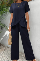 Textured Elegance two-piece set with asymmetrical top and wide-leg pants in navy blue.