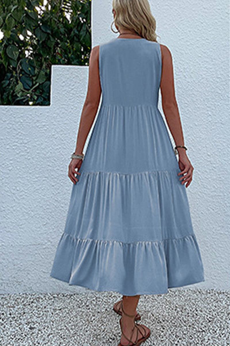 Back view of a woman wearing a light blue Bohemian tiered midi dress with a flowing, sleeveless design.