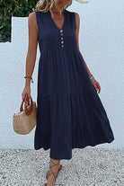 Bohemian tiered midi dress in navy with V-neck and button detail, sleeveless and flowy summer style