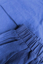 Close-up of a blue 100% cotton two-piece set with elastic waistband and textured fabric