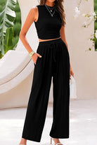 Woman wearing black Stroll & Hangout Ribbed Knit sleeveless top and wide-leg pants two-piece set outdoors