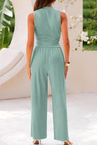 Woman wearing Stroll & Hangout Ribbed Knit two-piece set in light green, back view with wide-leg pants and sleeveless top.