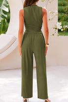 Back view of woman wearing olive green Stroll & Hangout Ribbed Knit sleeveless top and wide-leg pants set outdoors