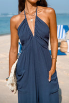 Sunshine On Sand halter-neck jumpsuit in navy blue beachwear with ruched neckline and wide-leg silhouette