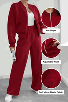 Woman wearing The Voyager Zip Set in red with full zipper sweatshirt and wide-leg joggers with adjustable waist made of soft micro-elastic fabric