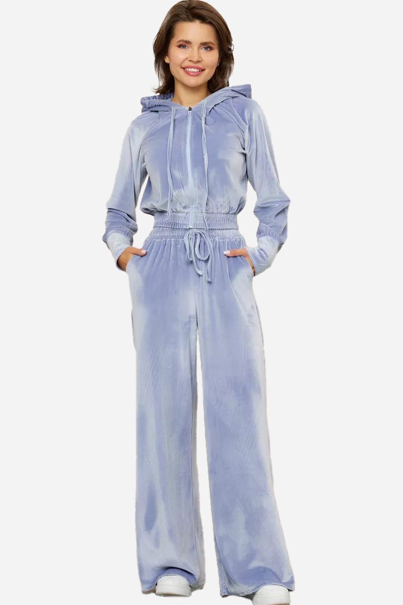 Light blue velour tracksuit with cropped hoodie and high-waist pants on model