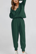 Unisex half-zip pullover and sweatpants set in dark green, casual and comfy polyester blend loungewear.