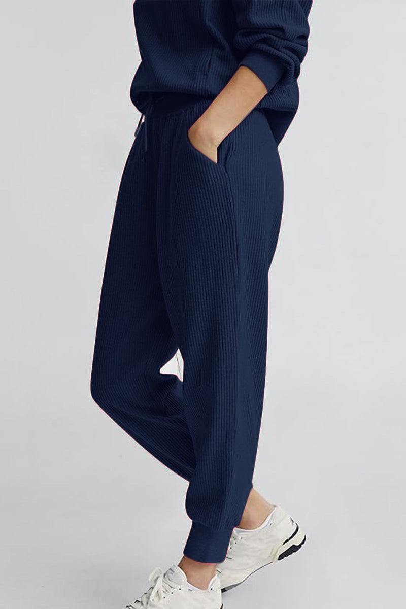 Unisex half-zip pullover and sweatpants set in navy blue with a casual, comfortable fit and breathable polyester blend fabric.