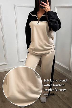 Woman wearing Colorblock Comfort Leisure Set with half-zip top and wide-leg pants in beige and black winter-weight fabric blend