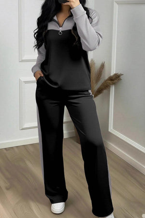 Woman wearing a Colorblock Comfort Leisure Set with half-zip top and wide-leg pants in black and gray.