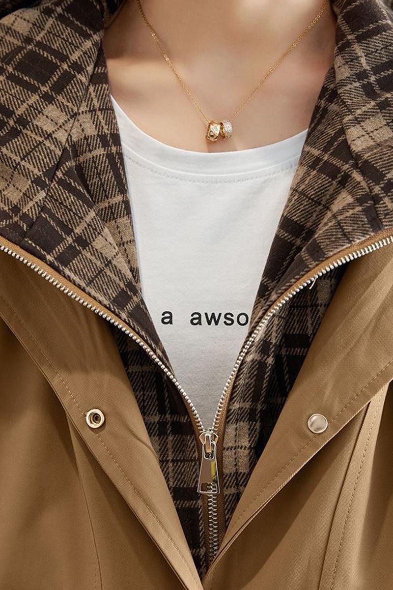 Close-up of City Explorer Plaid Windbreaker with beige wind-resistant shell and soft plaid lining on a white t-shirt background