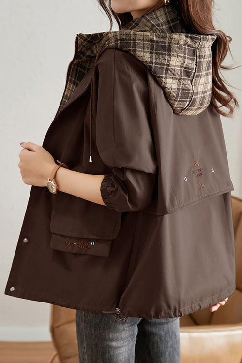 City Explorer Plaid Windbreaker with wind-resistant dark brown shell and plaid-lined hood, relaxed fit for women