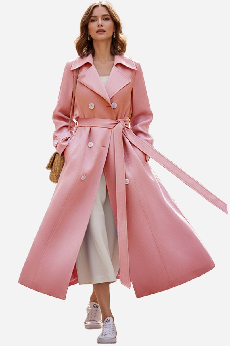 Woman wearing a pink timeless retro belted trench coat with double-breasted design and wide lapels.