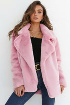 Pink open front oversized faux fur jacket with draped shawl collar on woman