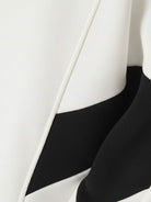 Woman wearing a Colorblock Comfort Tracksuit with contrast curved panels and stand collar jacket