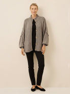 Oversized button-front knit cardigan with balloon sleeves and gold-tone buttons in chunky knit texture