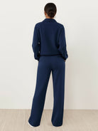 Woman wearing casual wrinkle-free polo set with quarter-button top and high-waisted pants