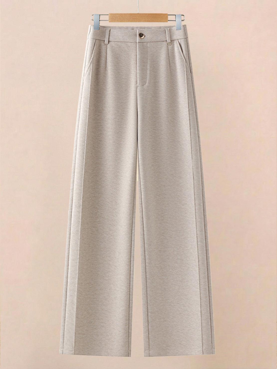 Beige thermal wool blend trousers with wide-leg cut and elastic back waist hanging on wooden hanger