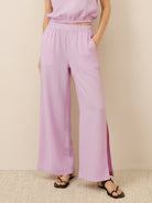 Lightweight linen-blend set with sleeveless top and wide-leg pants featuring elastic waistband and side slits
