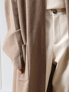 Long Australian Merino Wool cardigan with open front, patch pockets, and ribbed cuffs, perfect for layering in fall and winter