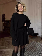 Oversized crew neck knit sweater with drop-shoulder sleeves and ribbed cuffs in neutral color