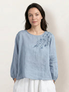 Cotton-linen embroidered blouse with relaxed boxy fit, 3/4 balloon sleeves, elastic cuffs, and subtle floral embroidery on shoulder