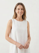 Woman wearing a lightweight cotton linen sleeveless maxi dress with a round neckline and flowy ankle-length silhouette