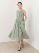 Sleeveless cotton linen pleated midi dress with pintuck bodice and A-line calf-length skirt