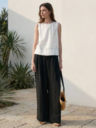 White Tencel-linen pleated wide-leg pants with hook-and-zipper closure and low-rise fit