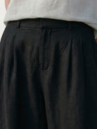 White Tencel-Linen pleated wide-leg pants with hook-and-zipper waist closure and floor-skimming silhouette