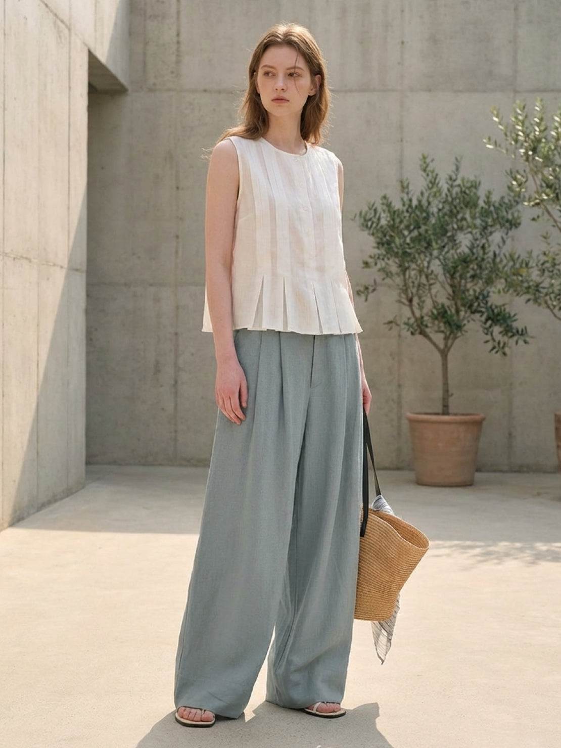 White Tencel-linen pleated wide-leg pants with hook-and-zipper waist closure and floor-skimming silhouette