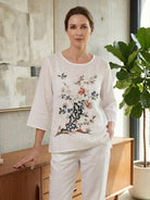 100% cotton linen hand-embroidered shirt with 3/4 flared sleeves and asymmetric hem