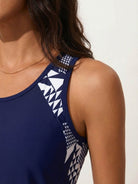 Racerback two-piece tankini set with relaxed-fit hip-length tank and mid-thigh swim shorts in tropical print
