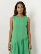 Lightweight cotton-linen summer midi dress with tiered skirt and relaxed drop-waist silhouette in soft pastel color