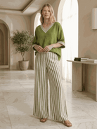 Woman wearing striped wide-leg co-ord set with oversized top and palazzo pants with elastic waist and side pockets