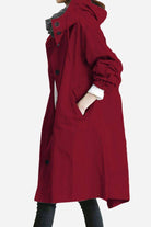 Water resistant oversized hooded windbreaker rain jacket in cherry red with adjustable fit and multiple pockets