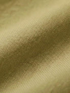 Close-up of soft, breathable cotton fabric in mustard yellow from the Short-sleeved Pullover & Wide Trouser Matching Set