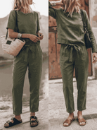 Model wearing relaxed cotton-linen set with short-sleeve top and straight-leg pants in monochrome tones