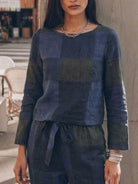 Woman wearing relaxed cotton-linen monochrome capsule outfit with longline top and wide-leg pants
