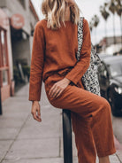 Woman wearing relaxed cotton-linen monochrome capsule outfit with longline top and wide-leg pants