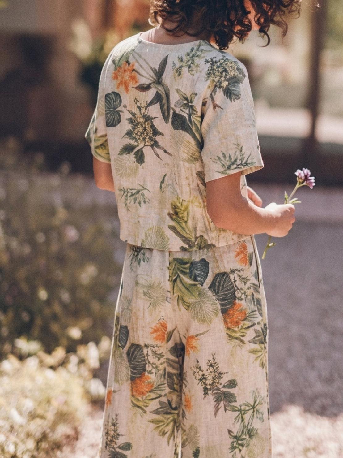 Woman wearing a loose fit co-ord set with a soft-tailored top and wide-leg bottoms in breathable cotton