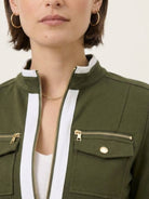 woman wearing sleek contrast zip two-piece outfit with black top and pants on white background