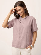 white 100% linen relaxed V-neck top with asymmetric button detail and short sleeves