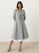 Elegant water-repellent A-line hooded raincoat with matching belt and insulated lining for women