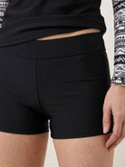 woman wearing swim shorts rash guard set with long raglan sleeves and matching boyshort bottoms