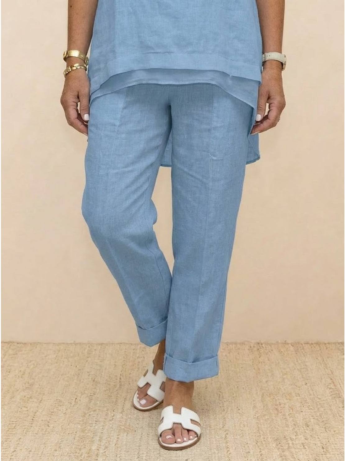Light blue asymmetrical two-piece trouser set with rolled cuffs and breathable fabric designed for casual and semi-formal wear.