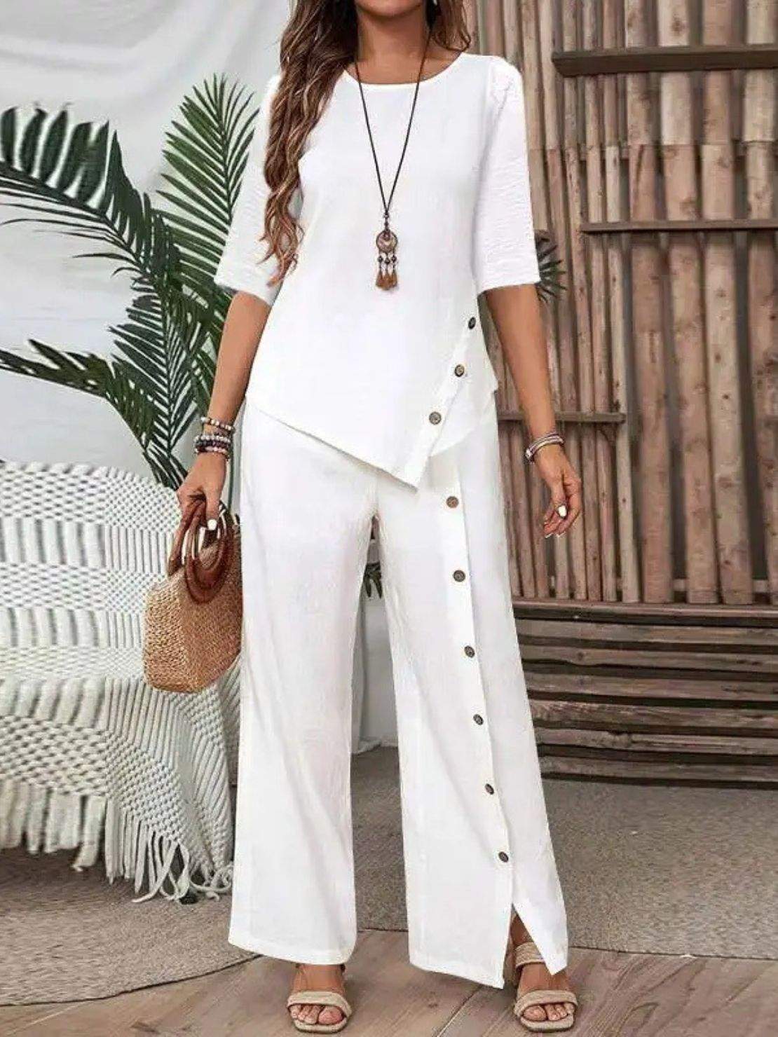 Woman wearing Asymmetry Flow Co-ord set with button-front top and flowing asymmetrical hem pants in soft fabric