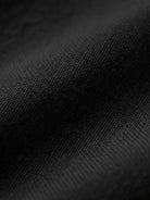 Close-up of soft black cotton fabric for short-sleeved pullover and wide trouser matching set