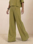 Olive green short-sleeved pullover with wide-leg matching trousers in lightweight cotton fabric.