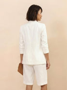 Woman wearing a blazer and high-waisted shorts two-piece set in premium fabric for a polished, slimming look